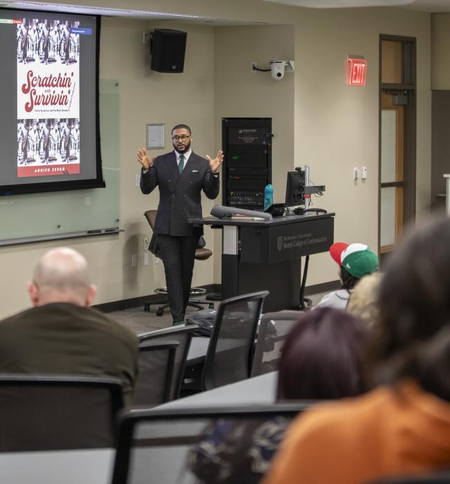 Professor Sebro speaking in front of classroom