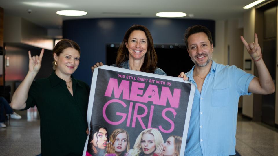 people holding movie poster