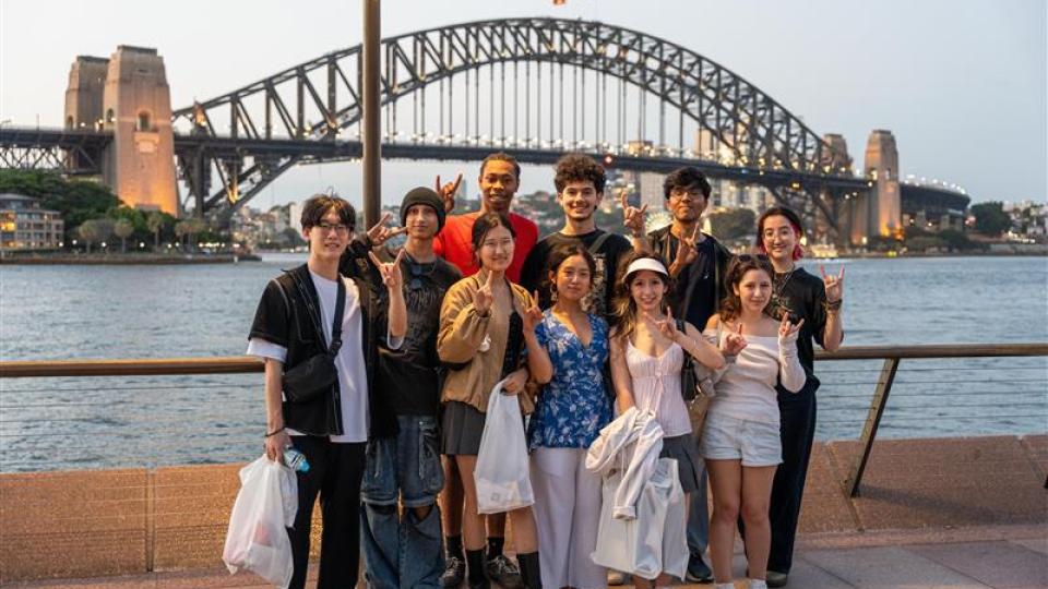 A group of UT Austin students pose in front of the Sydney Harbor Bridge in Sydney, Australia. 