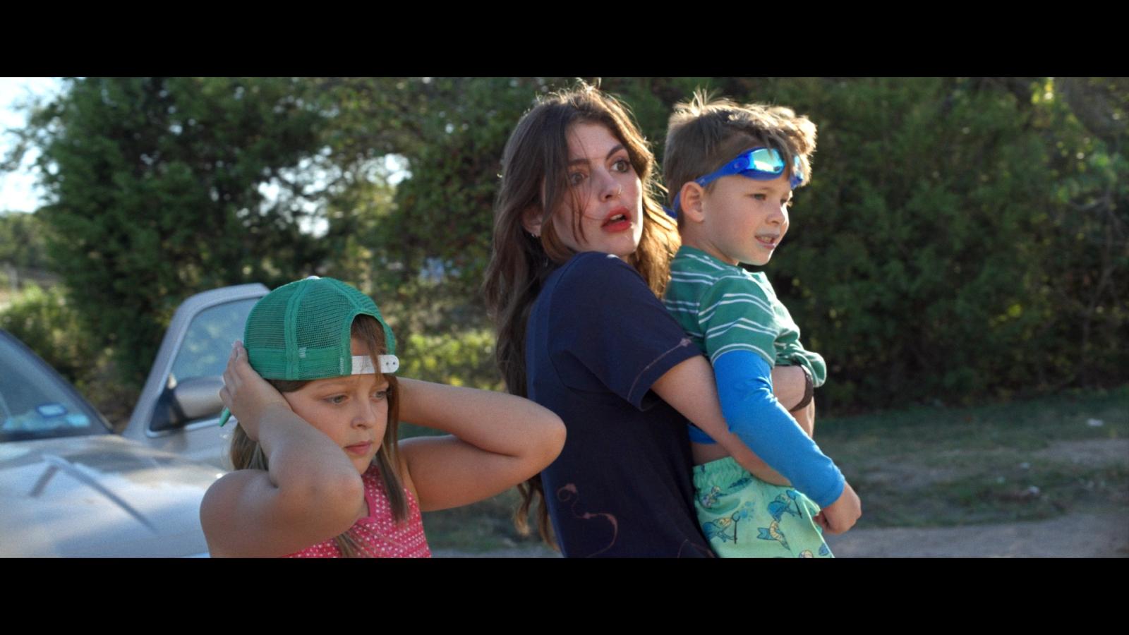 A still of Ava William's Film, "How Would You Like to Go Swimming?" showing a woman with two children.