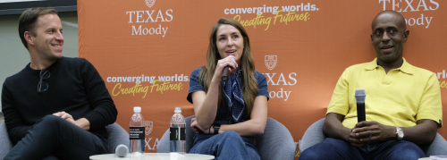 Jonathan Eshak, Margaret Galton, and Kevin Shivers in front of an orange Moody banner on a panel about the music business