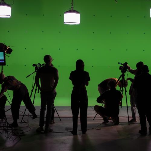 Students in front of green screen