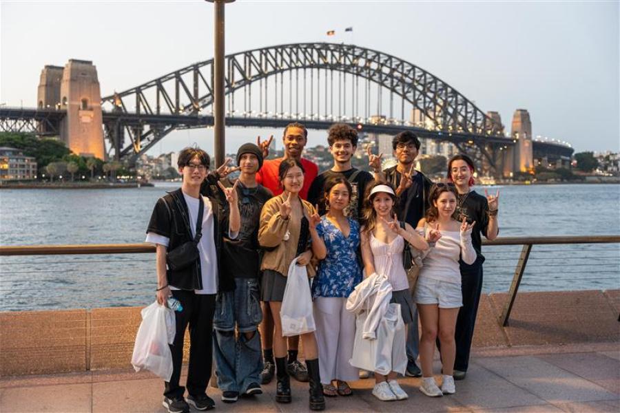 A group of UT Austin students pose in front of the Sydney Harbor Bridge in Sydney, Australia. 