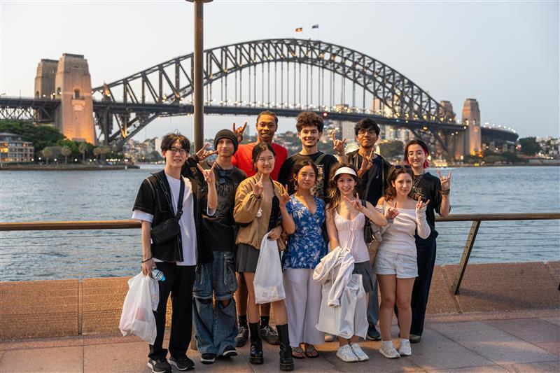 A group of UT Austin students pose in front of the Sydney Harbor Bridge in Sydney, Australia. 